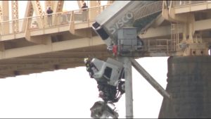 Read more about the article Crash leaves truck dangling over bridge in US, driver pulled to safety