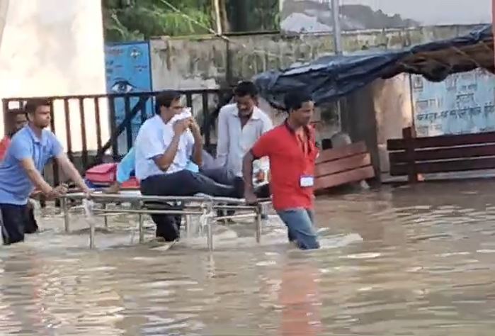 Video: With Road Flooded, Medical College Principal Taken Out On A Stretcher